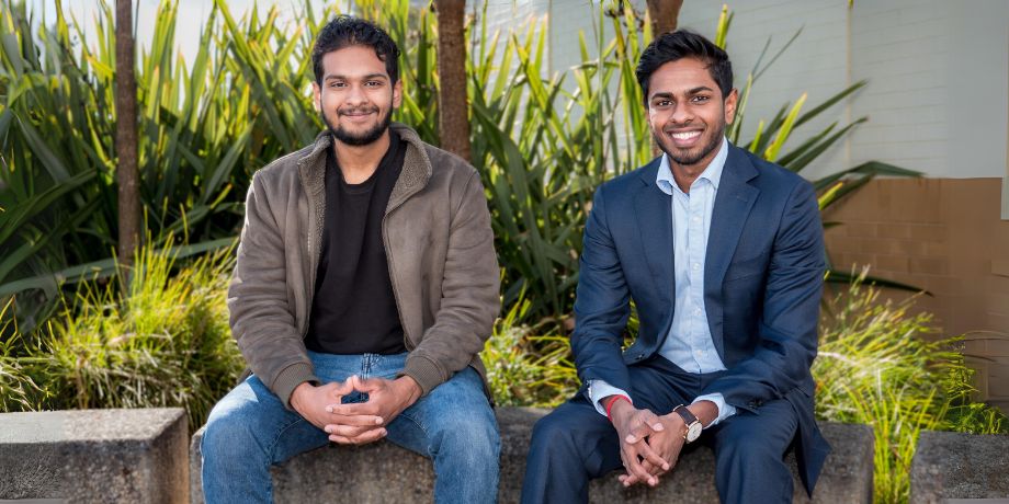 Dhinesh and Aryan sitting together smiling