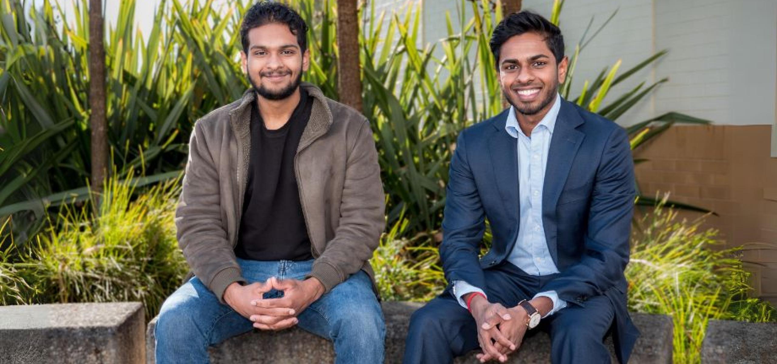Dhinesh and Aryan sitting together smiling